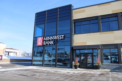 A sleek modern looking Minnwest bank building with big windows 