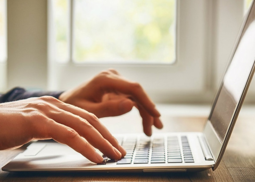 hands and a laptop computer